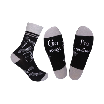 black & gray crew socks with a book pattern and the words "go away...i'm i'm reading" on the sole   
