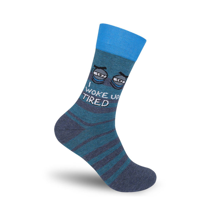 Crew socks in teal and grey featuring a pair of cartoon eyes and the text 'I Woke Up Tired'. }}