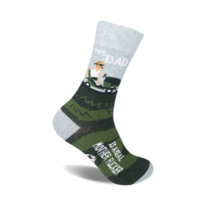 Crew socks in gray, green, and white. Design features a cartoon dad driving a golf cart and the phrase 'This Dad Is A Real Mother Fucker'.