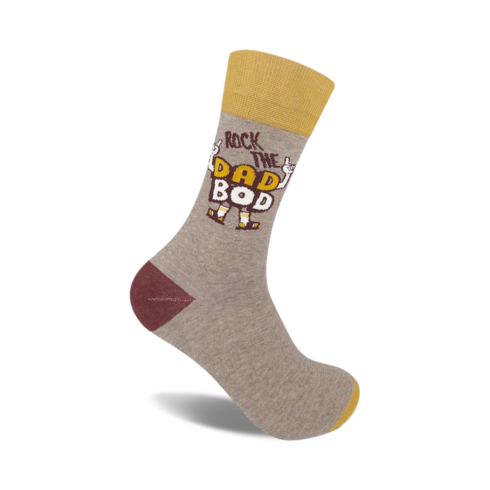 Crew socks in grey, mustard yellow, and burgundy.  Features a graphic design that says 'Rock the Dad Bod' with cartoon arms.