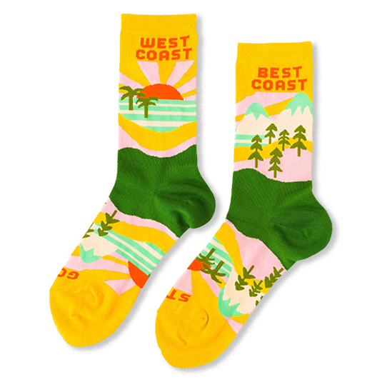 Yellow and green crew socks reading West Coast with palm trees and a sunset, and Best Coast with pine trees and mountains.