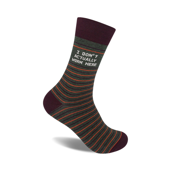 Crew socks in olive green with thin orange stripes and a maroon cuff. The text 'I DON'T ACTUALLY WORK HERE' is printed on the sock.