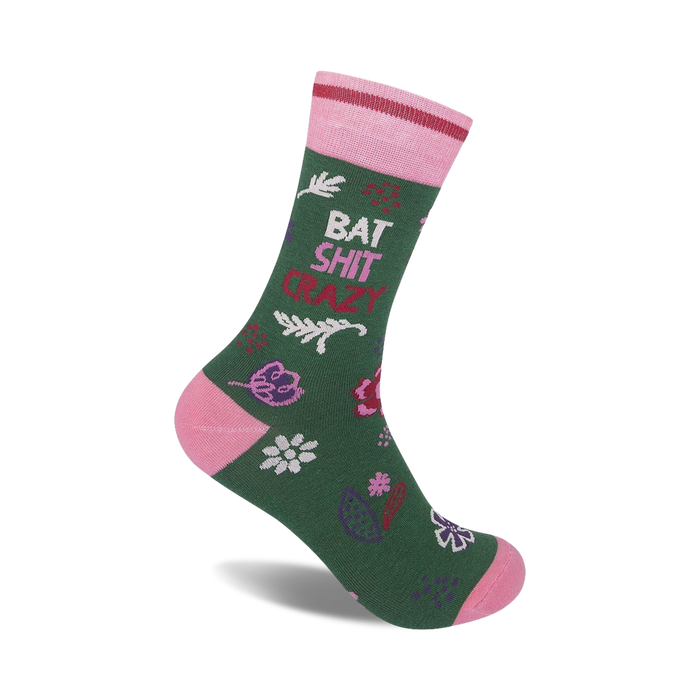 Green crew socks with pink accents. Features a playful 'Bat Shit Crazy' phrase and a whimsical floral pattern.