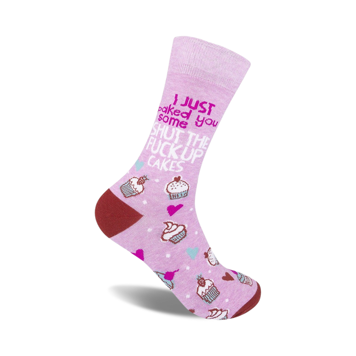 Lilac crew socks with a playful 'Shut The Fuck Up Cakes' slogan, pink cupcake illustrations, and maroon heel and toe.