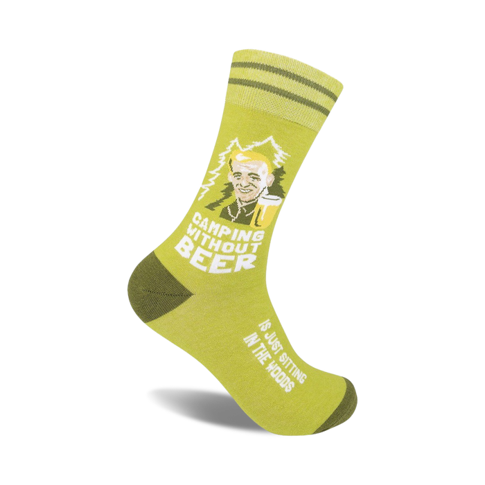 Olive green crew socks with a cartoon of a man drinking beer and the text 'Camping Without Beer'.  Features olive green stripes near the cuff.