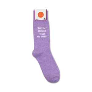 Product shot showing lavender 'The Tiny Humans Stole My Sanity' socks in their packaging.