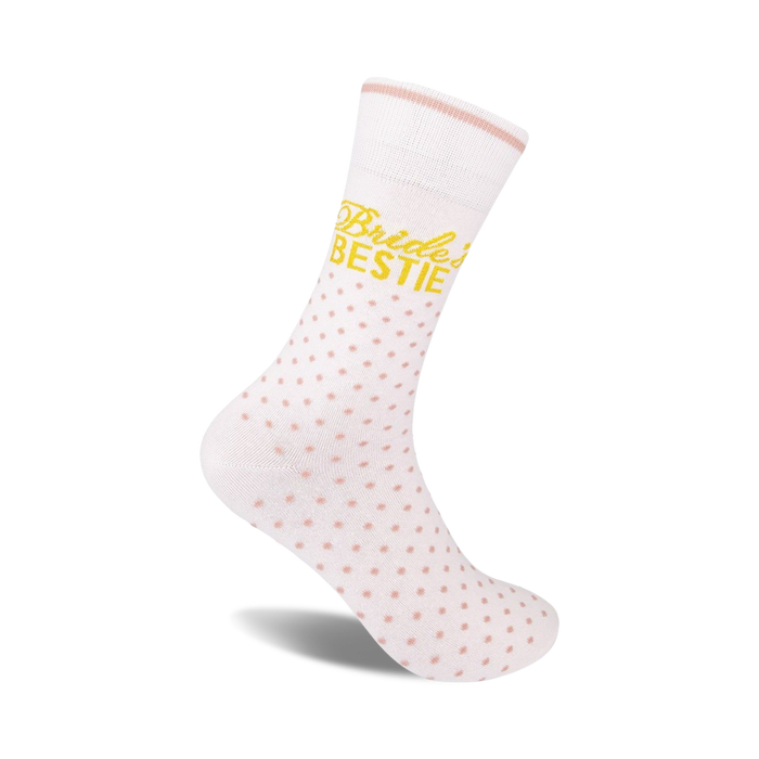 White crew socks with pink polka dots and 'Bride's Bestie' in gold lettering. A perfect gift for bridesmaids!