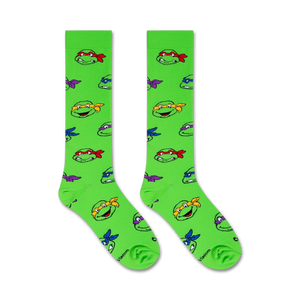 Flat lay image showing two TMNT knee-high socks on a white background.