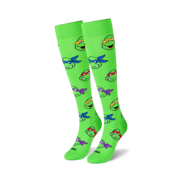 tmnt heads knee-high socks feature teenage mutant ninja turtles heads. green socks with different colored turtles. for men and women.  