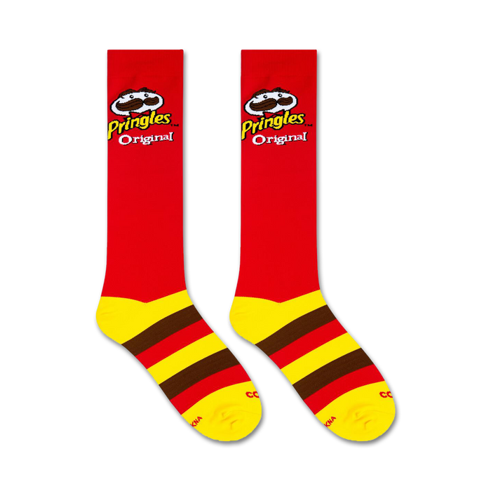 A pair of red socks with yellow and brown stripes at the top and brown toes and heels. The word Pringles and the Pringles mascot are on the front of each sock in brown and yellow.
