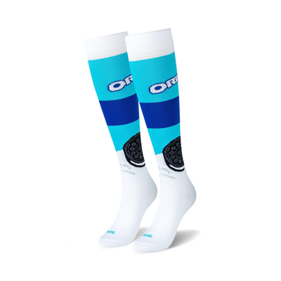 Pair of white knee-high compression socks with blue and teal stripes and Oreo cookie graphics.