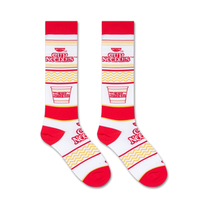 A pair of white socks with a red toe, heel, and Cup Noodles logo.
