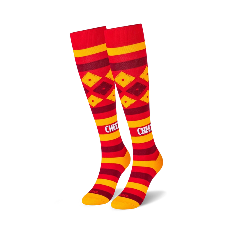 Pair of red and gold knee-high socks with a Cheez-It-inspired design. Features horizontal stripes and diamond patterns.
