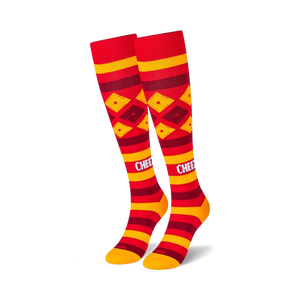 Pair of red and gold knee-high socks with a Cheez-It-inspired design. Features horizontal stripes and diamond patterns.
