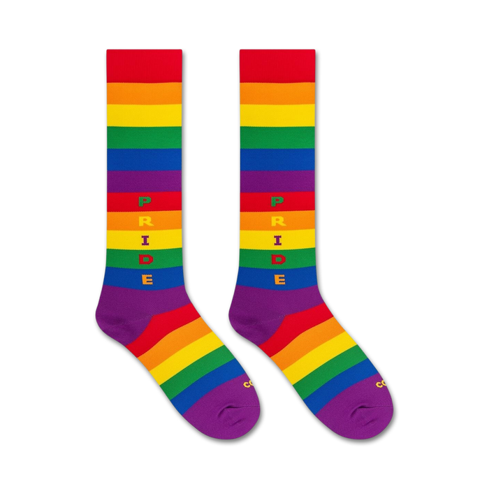 Flat lay image of a pair of rainbow pride knee-high socks.