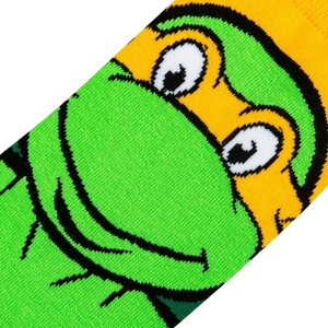 Close-up detail shot showcasing the texture and colors of Michelangelo's face on the TMNT socks.