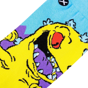 A yellow cartoon monster with a red eye and purple teeth is depicted with its mouth wide open against a blue background.