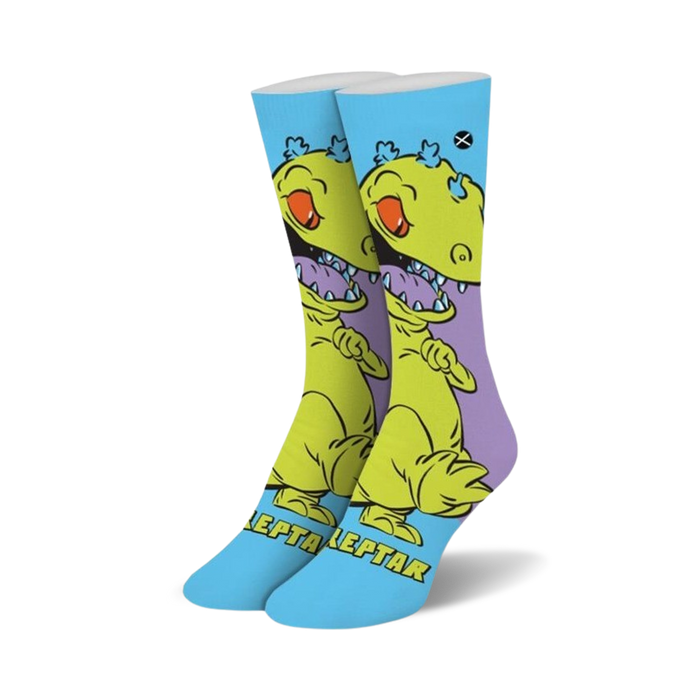 Pair of crew socks featuring Reptar from Rugrats.  Yellow dinosaur design on a light blue background with purple accents.