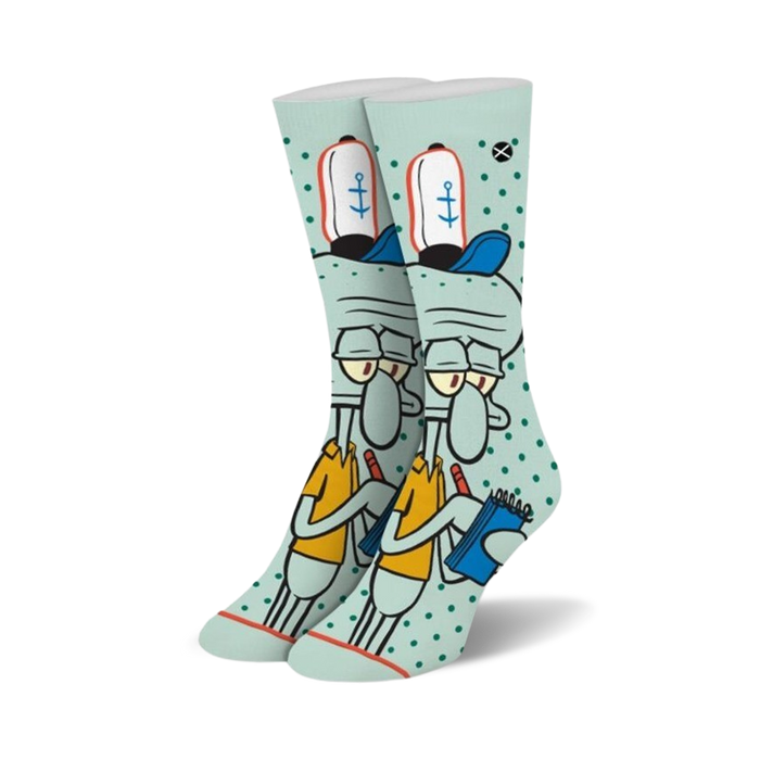 Crew socks in teal featuring Squidward Tentacles from Spongebob Squarepants. He's depicted holding a notebook, wearing his signature hat, on a teal background with white polka dots.