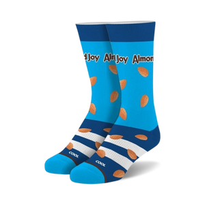 A pair of crew socks in bright blue with scattered almond images and a chocolate-striped cuff. The text 'Almond Joy' is visible.