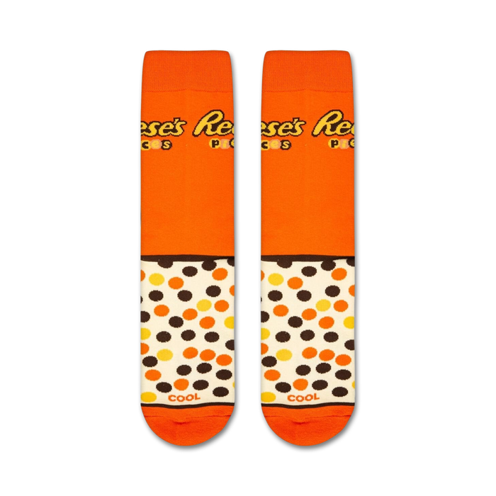 An orange sock with a brown and yellow pattern of the word 