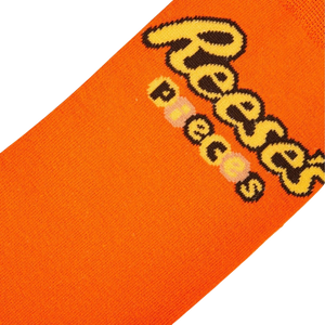 Close-up detail shot of the Reese's Pieces logo on the orange part of the sock.