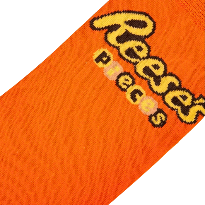 Close-up detail shot of the Reese's Pieces logo on the orange part of the sock.