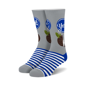 Pair of crew socks. Gray background with a York Peppermint Pattie design, blue stripes at the cuffs.