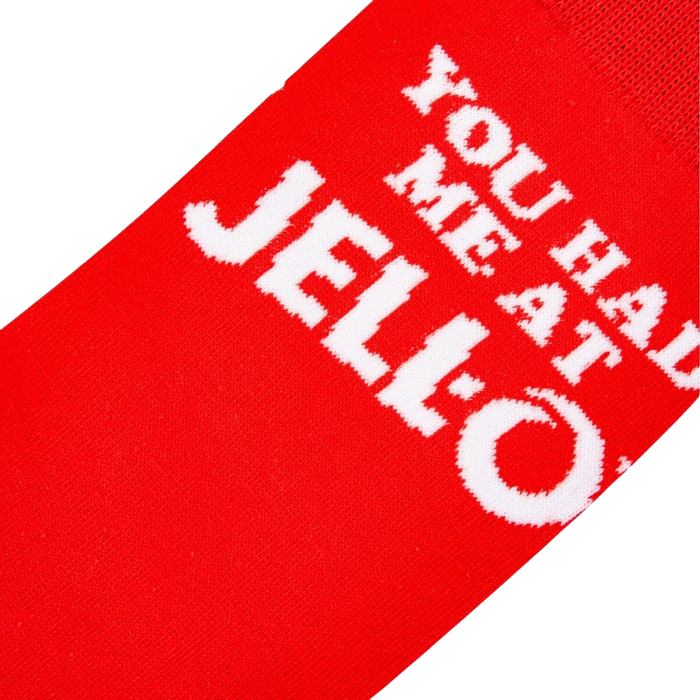 Close-up detail shot highlighting the 'You Had Me At Jell-O' text on the red sock.