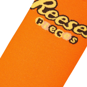 Close-up detail shot of the Reese's Pieces logo on the socks.