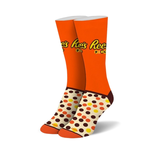 Pair of crew socks in orange, brown, and cream. Features Reese's Pieces logo and polka dot pattern.