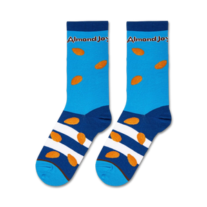 A pair of blue socks with a white and brown striped pattern around the ankle and brown almond-shaped objects all over. The word 