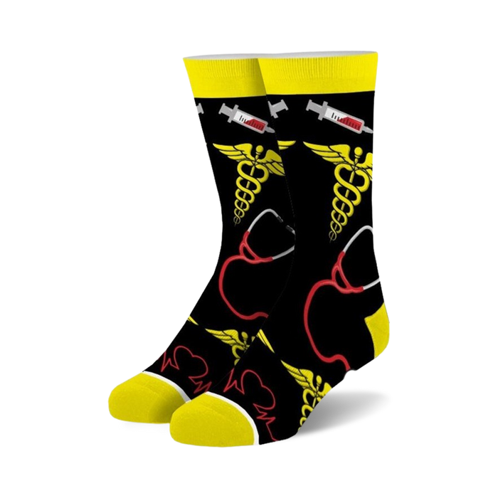 Pair of crew socks in black with yellow and red medical symbols: caduceus, stethoscope, and EKG line.  Fun and quirky design.