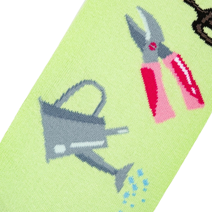 Detailed close-up of the sock design, focusing on a watering can and pink gardening shears.