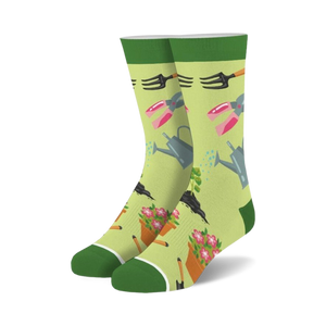 Pair of crew socks, light green background with gardening tools (watering can, shears, trowel) and flowers in pink and orange.