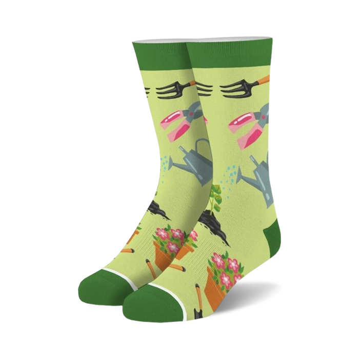 Pair of crew socks, light green background with gardening tools (watering can, shears, trowel) and flowers in pink and orange.