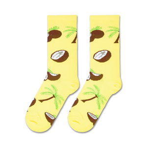 A yellow sock with a pattern of brown coconut halves and green palm trees.