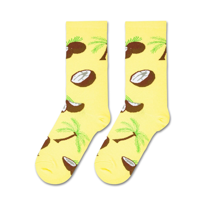 A yellow sock with a pattern of brown coconut halves and green palm trees.
