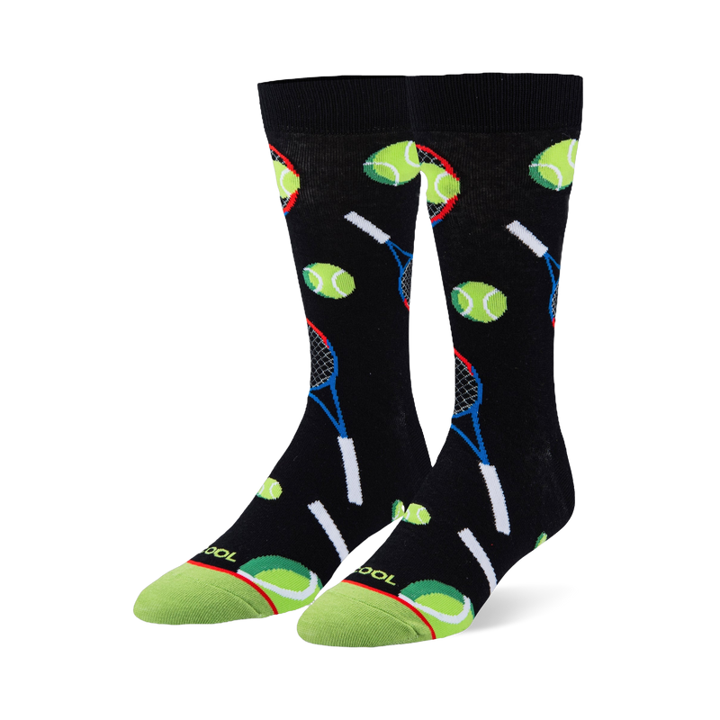 Black crew socks featuring a pattern of neon green tennis balls and blue and red rackets with a bright green toe cap.