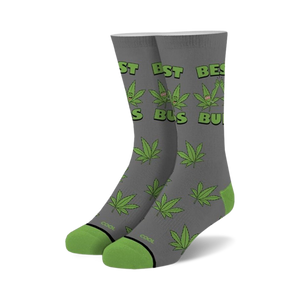 Pair of gray crew socks with green cannabis leaf pattern and 'Best Buds' text.  Features cartoon marijuana leaves with faces.