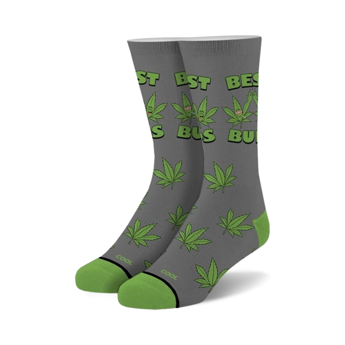 Pair of gray crew socks with green cannabis leaf pattern and 'Best Buds' text.  Features cartoon marijuana leaves with faces.