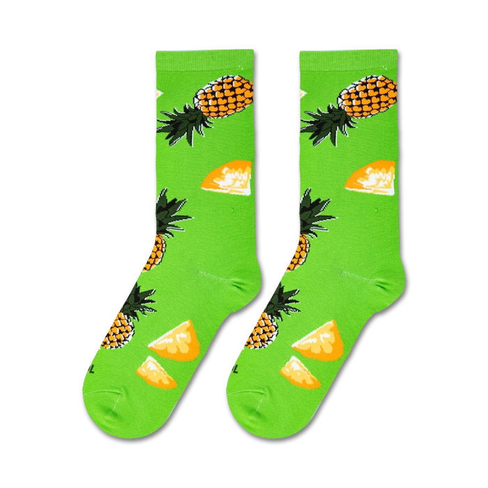 Flat lay showcasing a pair of lime green crew socks with a pineapple design.