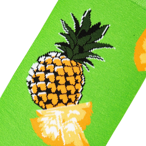 A green sock with a pattern of pineapples.