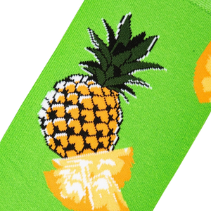 Close-up detail of a pineapple graphic on a lime green sock.