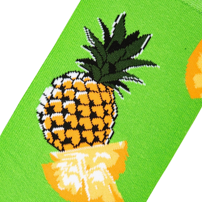 Close-up detail of a pineapple graphic on a lime green sock.