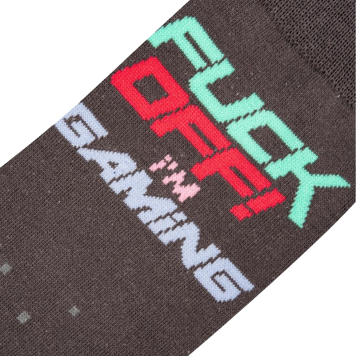 Close-up detail shot of the sock's 'Fuck Off I'm Gaming' text and pixelated design.