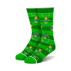 Crew socks in green and blue featuring a soccer field design with cartoon players.