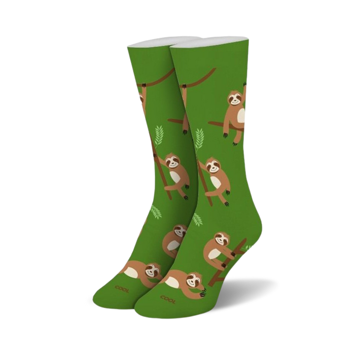 Pair of green crew socks with repeating pattern of brown sloths hanging on branches.