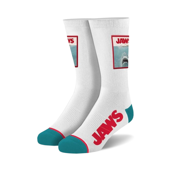 white crew length socks with blue toe and heel. jaws wordmark and shark image patch. cotton material.   }}