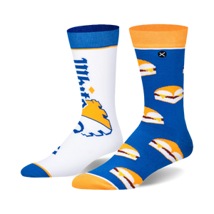 Pair of crew socks; one white with White Castle logo, the other blue with White Castle slider pattern. Orange and blue cuffs.